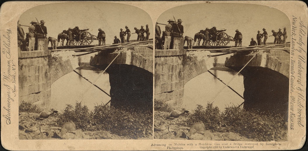 Advancing on Malolos with a Hotchkiss Gun over a Bridge destroyed by Insurgents, Philippines.